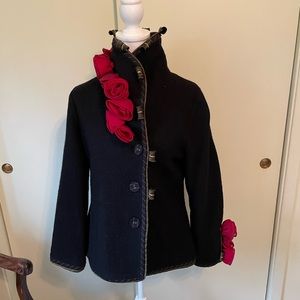 Women’s black wool jacket with organdy roses and high collar.